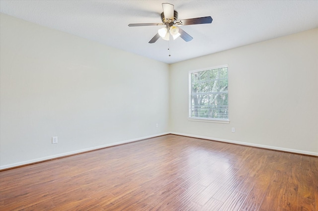 spare room featuring hardwood / wood-style floors and ceiling fan