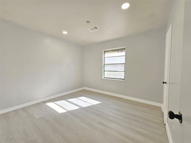 unfurnished room with light wood-type flooring