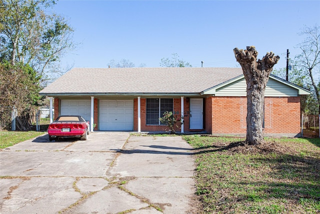 ranch-style home with a garage, driveway, brick siding, and roof with shingles