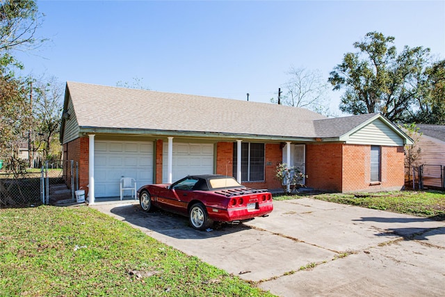 ranch-style house featuring a garage and a front yard