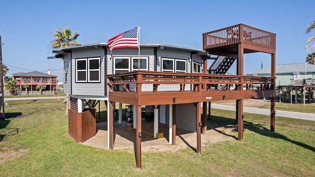 back of house featuring a yard, a patio area, and a wooden deck