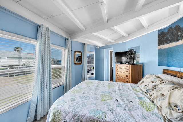 bedroom with vaulted ceiling with beams