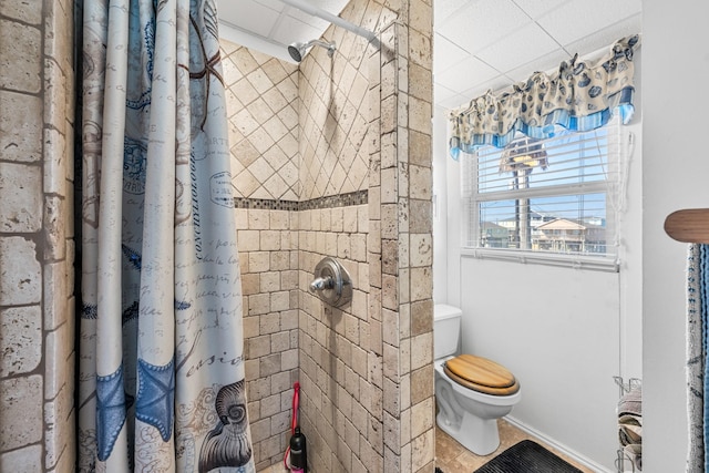 bathroom featuring tile patterned flooring, a shower with curtain, and toilet