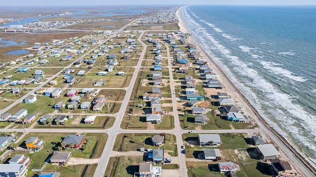 drone / aerial view featuring a water view and a beach view