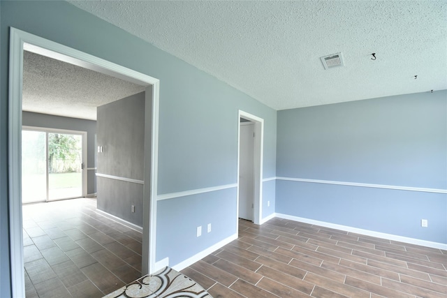 spare room featuring a textured ceiling