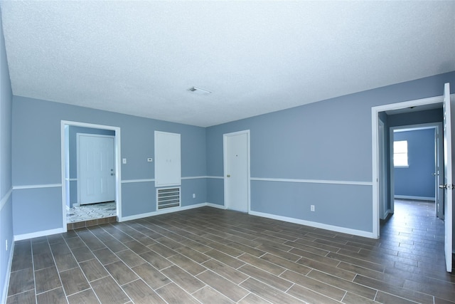 unfurnished living room featuring a textured ceiling