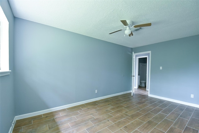 empty room with a textured ceiling and ceiling fan