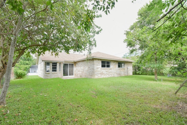 rear view of house with a lawn