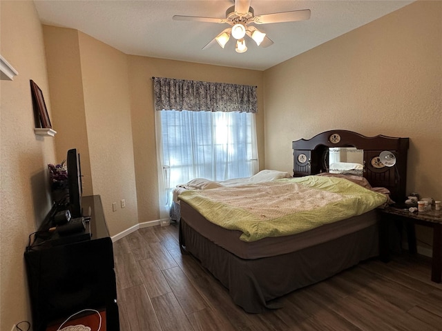 bedroom with ceiling fan and dark hardwood / wood-style flooring