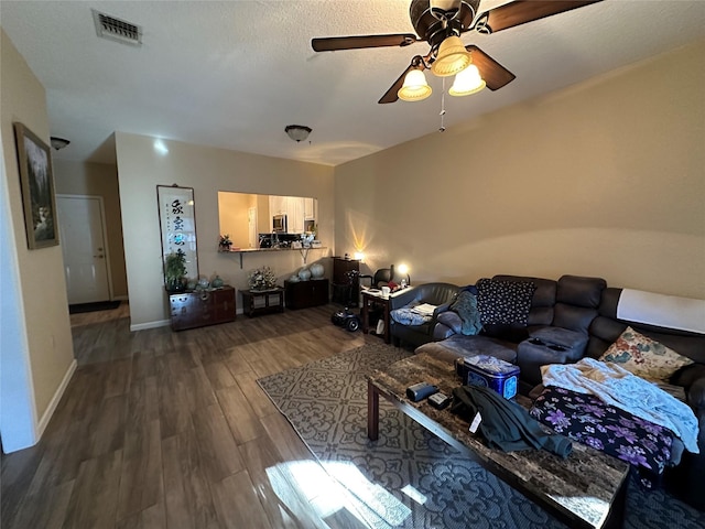 living room featuring hardwood / wood-style flooring and ceiling fan