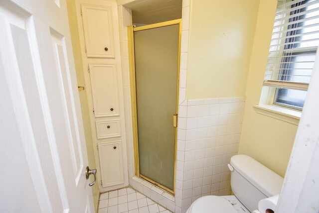 full bathroom with a shower stall, tile walls, and a wealth of natural light