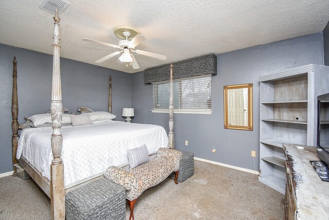 bedroom with carpet floors, visible vents, a textured ceiling, and baseboards