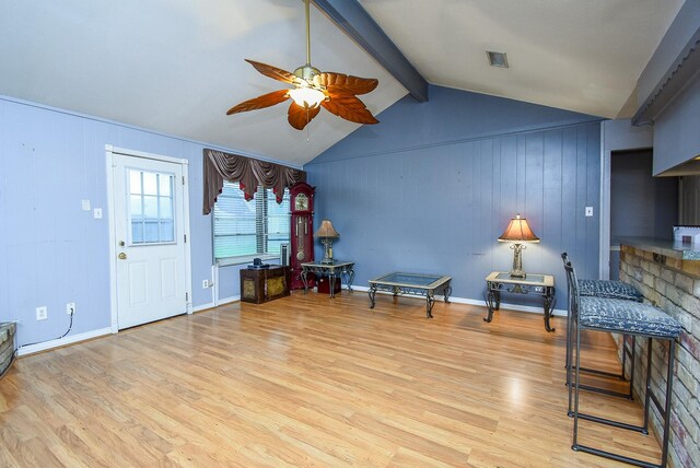 unfurnished room with light wood finished floors, visible vents, baseboards, a ceiling fan, and vaulted ceiling with beams