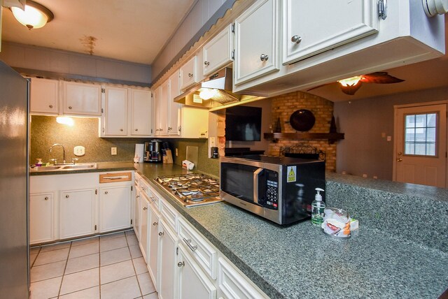 kitchen featuring appliances with stainless steel finishes, a sink, and white cabinets