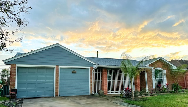 ranch-style house with a garage and a lawn