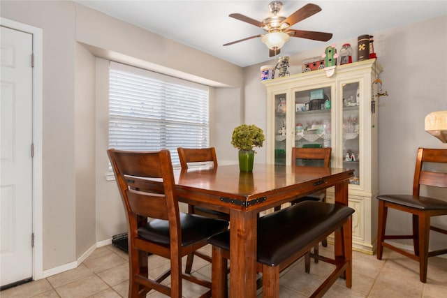 dining space featuring light tile patterned floors and ceiling fan