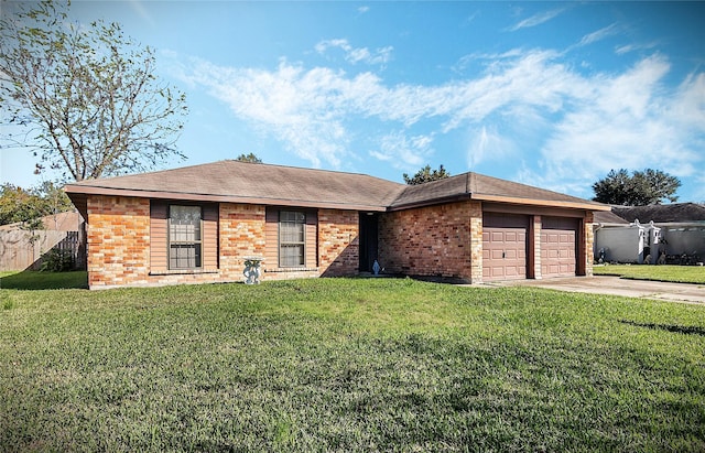 ranch-style home with a garage and a front lawn