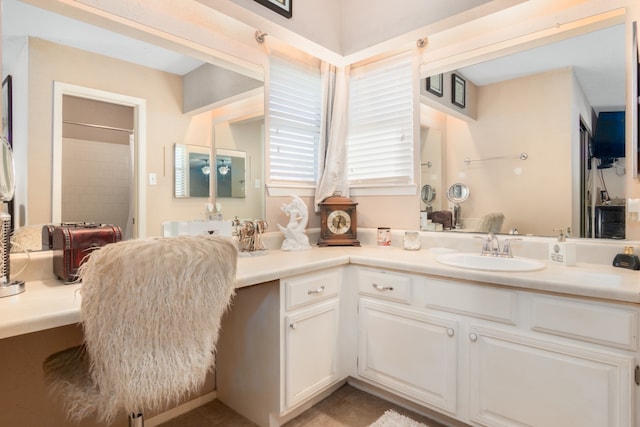 bathroom featuring tile patterned floors, a shower, and vanity