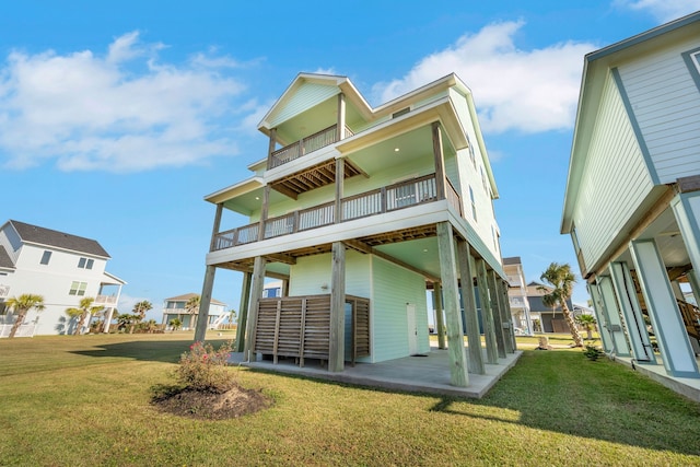 rear view of property featuring a yard and a balcony