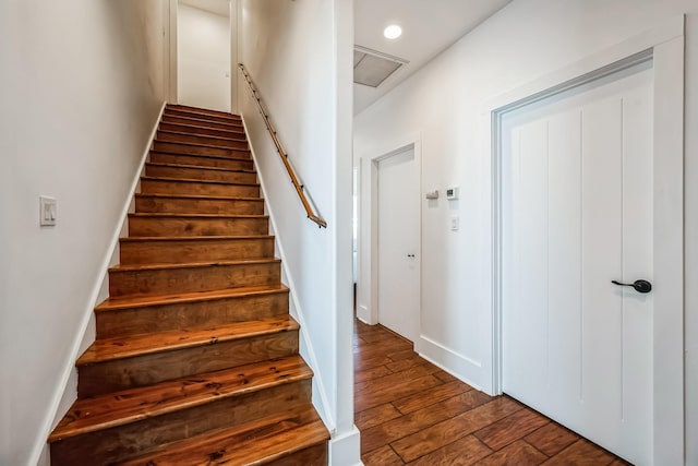 staircase featuring hardwood / wood-style flooring