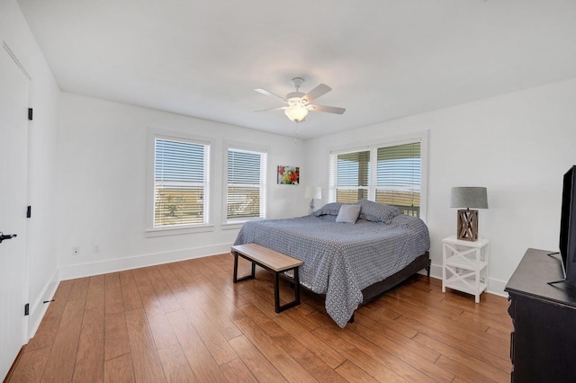 bedroom with hardwood / wood-style floors and ceiling fan