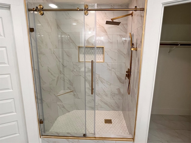 bathroom featuring a shower with shower door