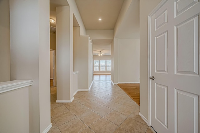 hall with light tile patterned floors