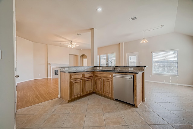 kitchen with dishwasher, sink, hanging light fixtures, ceiling fan, and light tile patterned floors