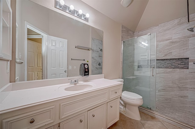 bathroom featuring walk in shower, tile patterned flooring, lofted ceiling, toilet, and vanity