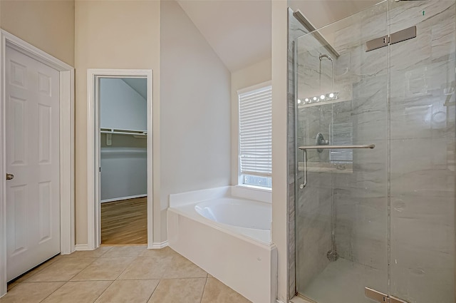 bathroom featuring tile patterned floors, plus walk in shower, and lofted ceiling