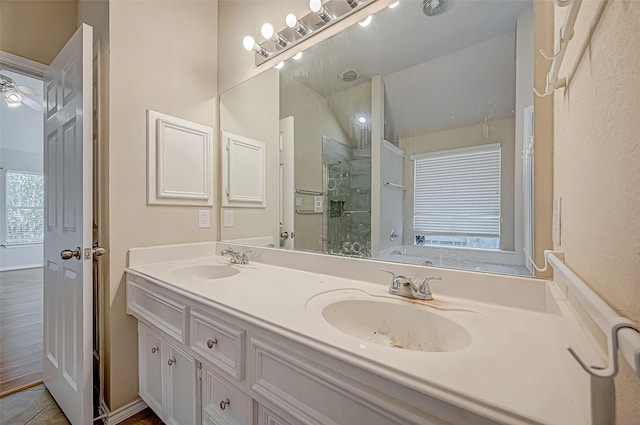 bathroom with a shower, vanity, and tile patterned floors