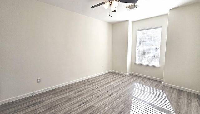 unfurnished room with ceiling fan and wood-type flooring