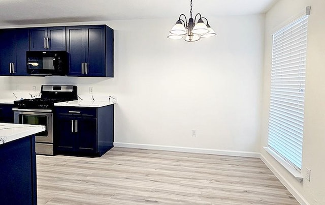 kitchen with pendant lighting, plenty of natural light, gas stove, and an inviting chandelier