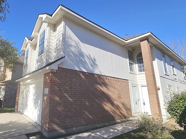 view of side of home featuring a garage