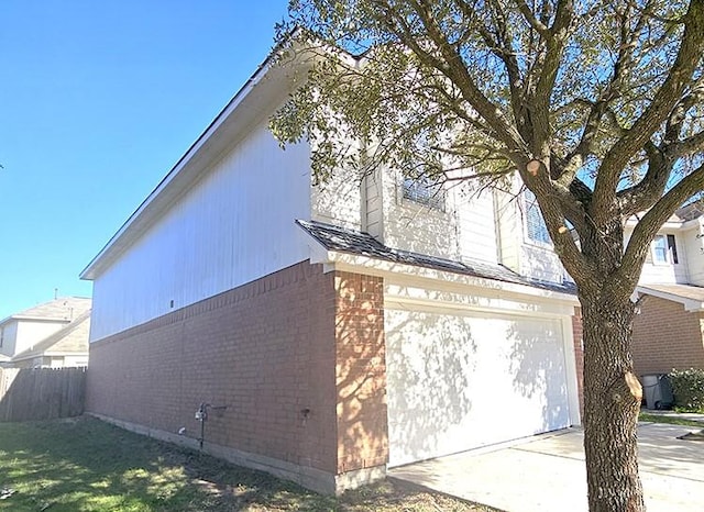 view of side of home with a lawn and a garage