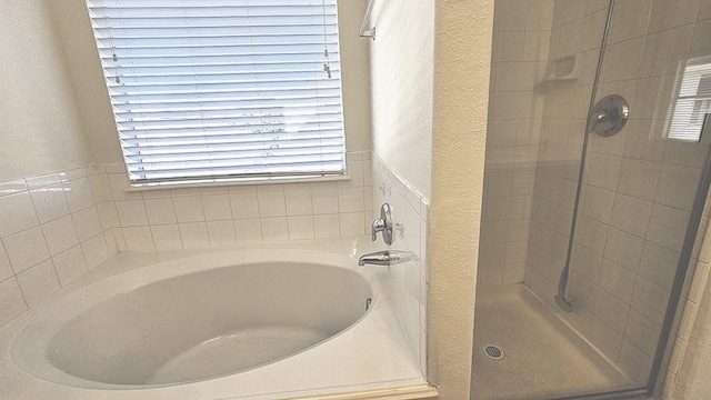 bathroom featuring separate shower and tub