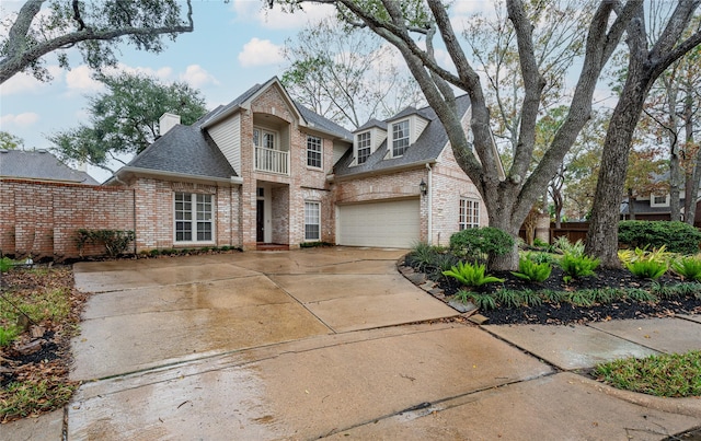 view of front of property with a balcony and a garage