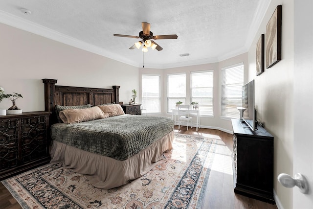 bedroom with ceiling fan, crown molding, a textured ceiling, and hardwood / wood-style flooring