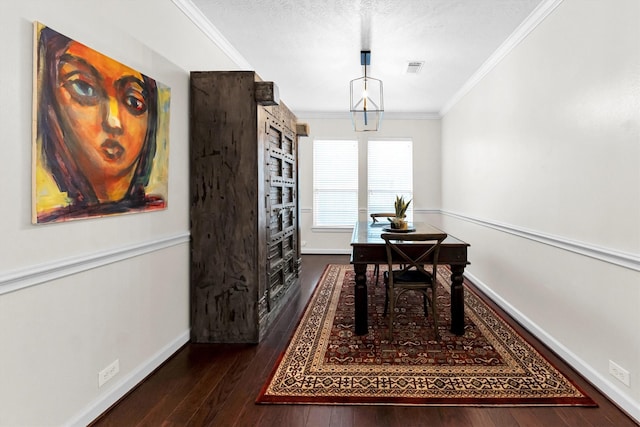 dining area featuring a textured ceiling, dark wood-type flooring, and ornamental molding