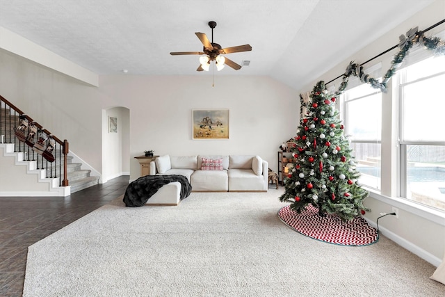 living room featuring ceiling fan and vaulted ceiling