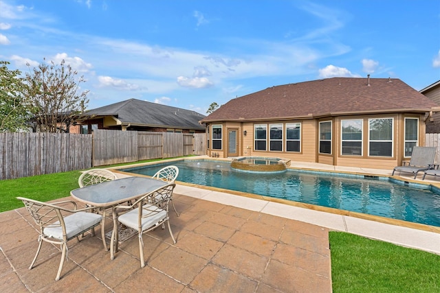 view of pool featuring a patio area and an in ground hot tub