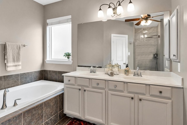 bathroom with plus walk in shower, ceiling fan, and vanity