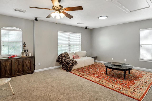 living room with ceiling fan, carpet flooring, and a healthy amount of sunlight