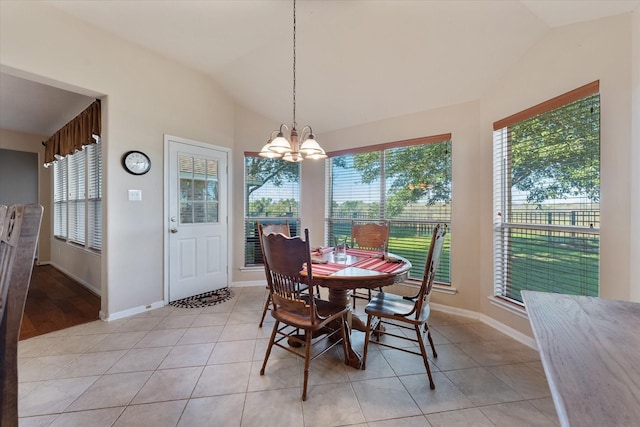 tiled dining room featuring plenty of natural light, lofted ceiling, and a notable chandelier