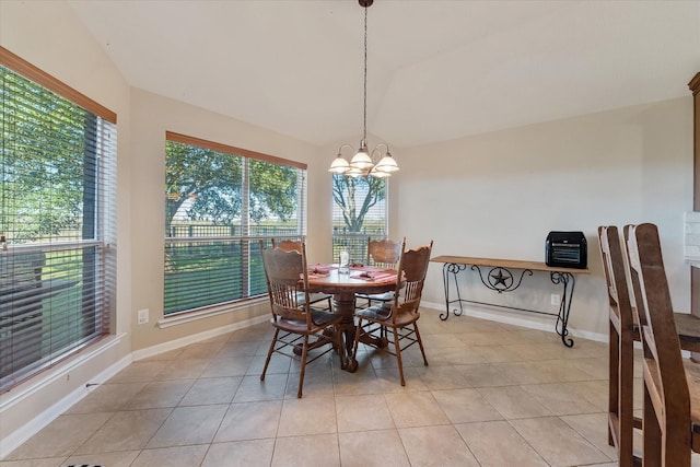 tiled dining space with a chandelier and vaulted ceiling