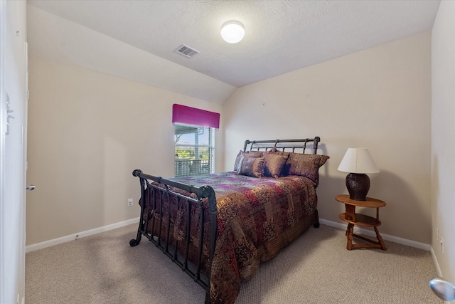 bedroom featuring light carpet and vaulted ceiling