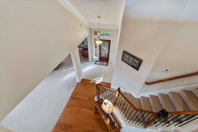 entrance foyer featuring hardwood / wood-style flooring, ornamental molding, and french doors