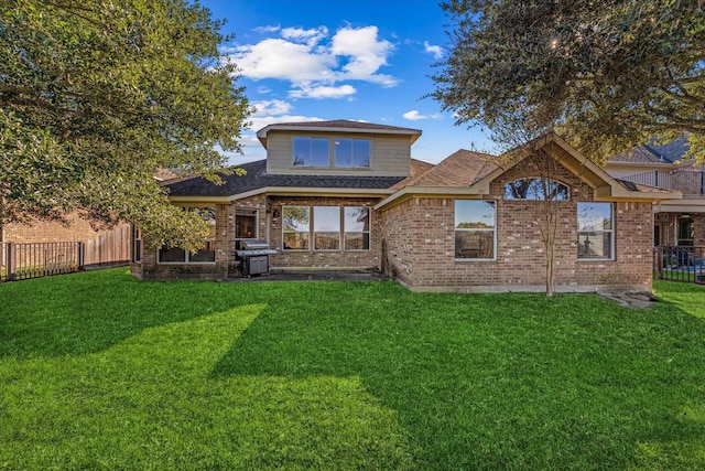 back of house featuring a lawn