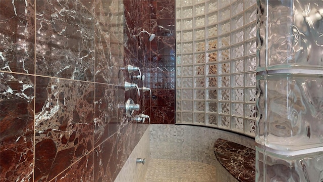 bathroom featuring tile walls and tiled shower