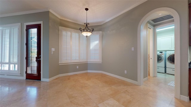 unfurnished dining area featuring plenty of natural light, washing machine and dryer, and ornamental molding